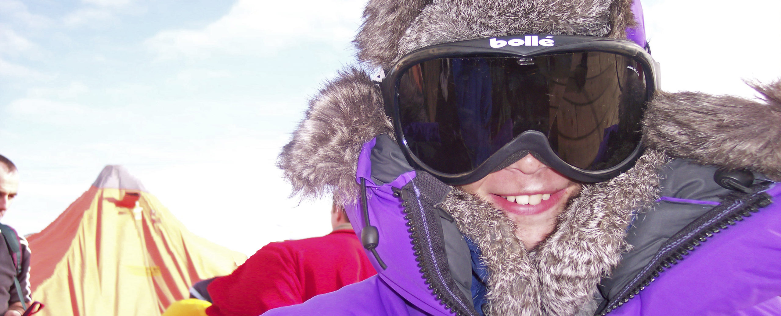 A person wearing winter clothing and goggles looking into the camera