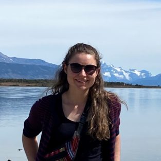 A person standing in front of a body of water