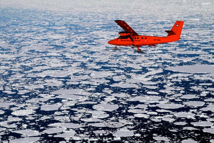 A plane flying over a body of water