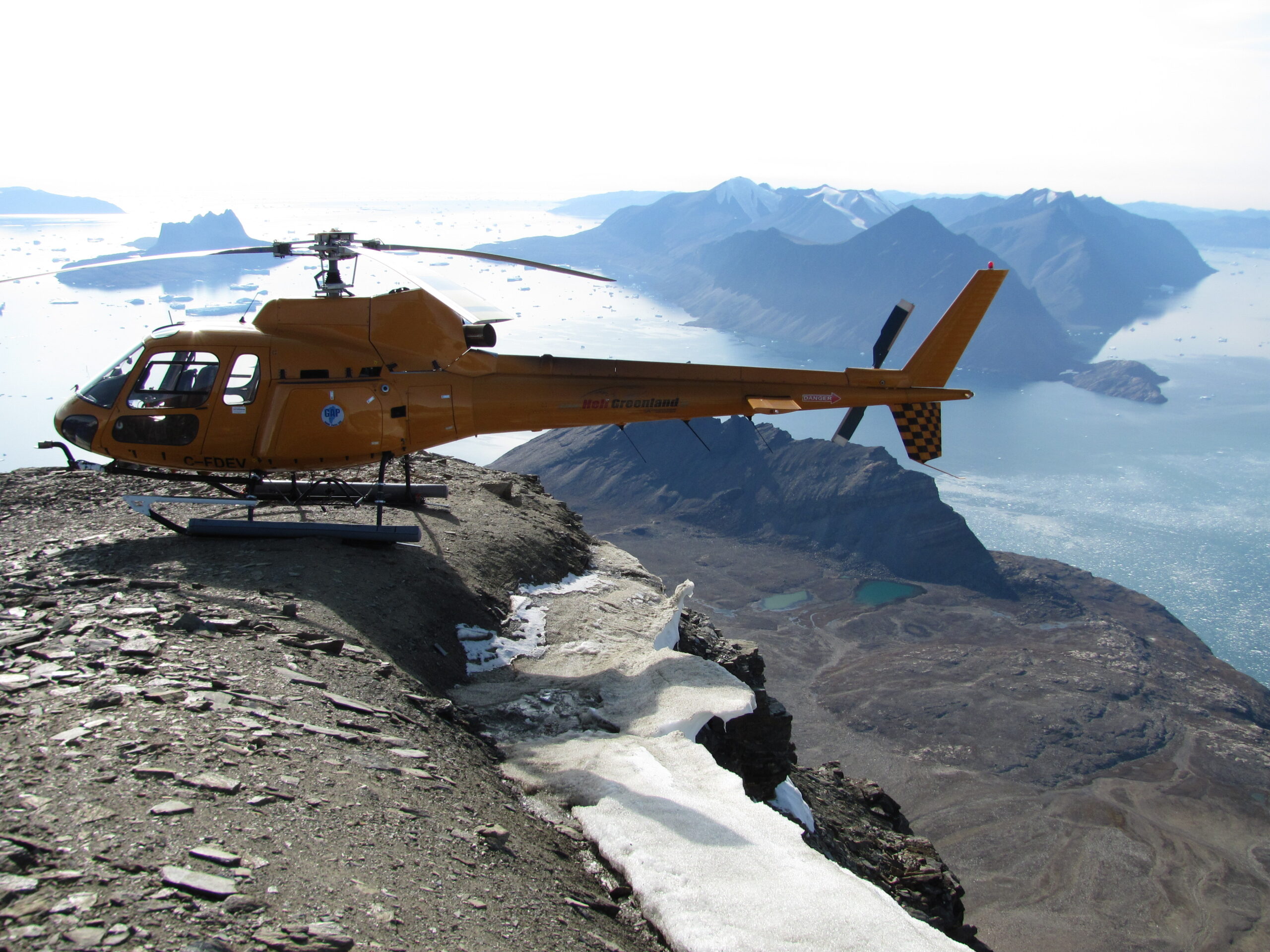 A helicopter sitting on top of a mountain
