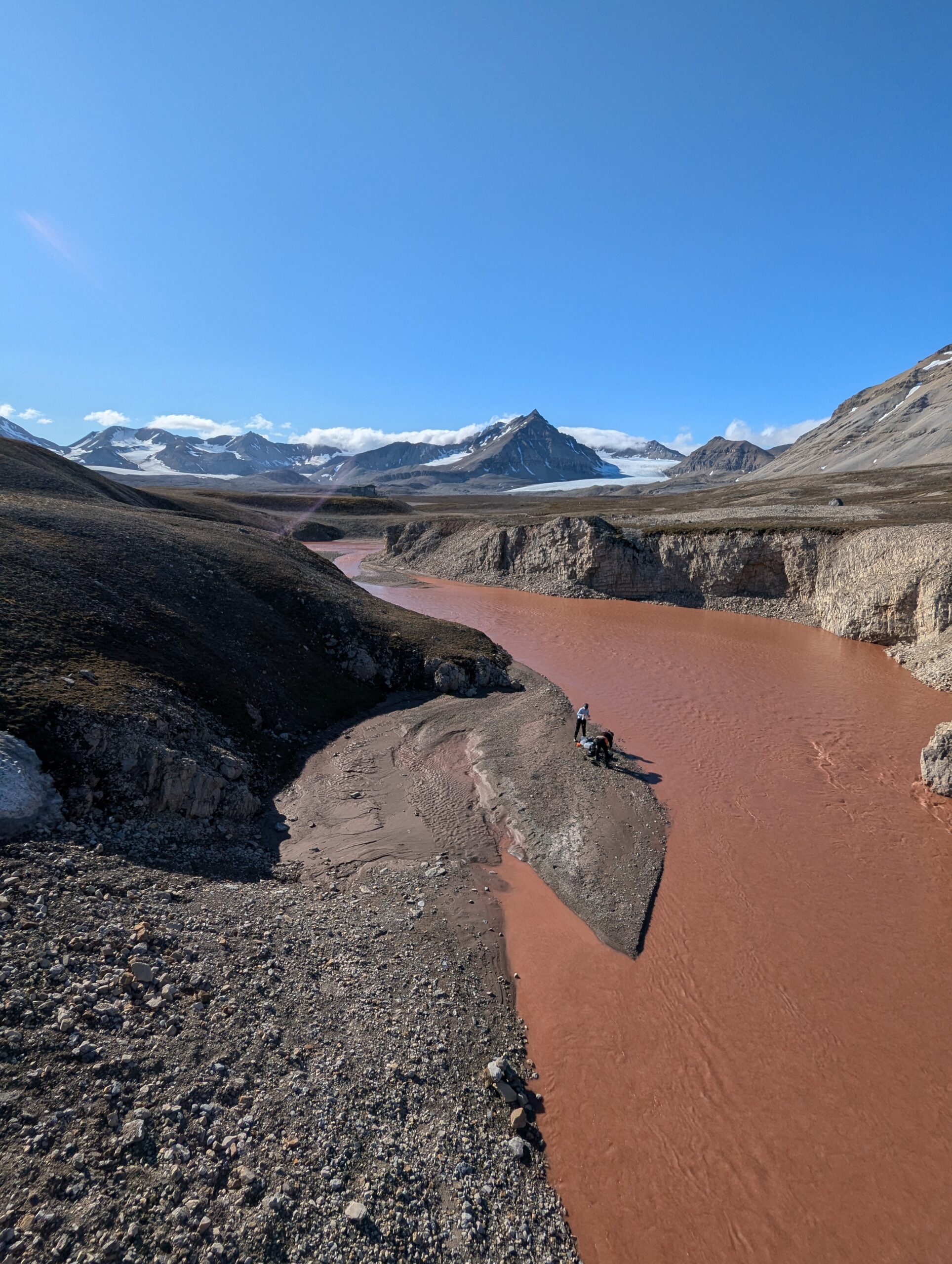 A brown river flowing between rocks