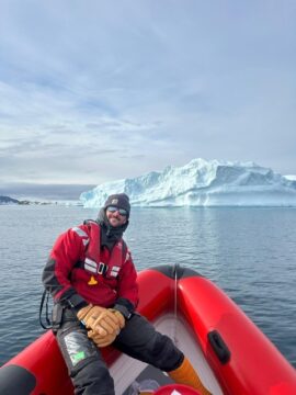 A man sitting in a boat on a body of water