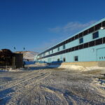 Photo of a snowy building in Antarctica with solar panels installed