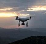 A drone flying over a mountainous landscape