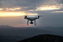 A drone flying over a mountainous landscape