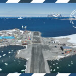 A postcard style image of a runway and a large blue building surrounded by water and snow