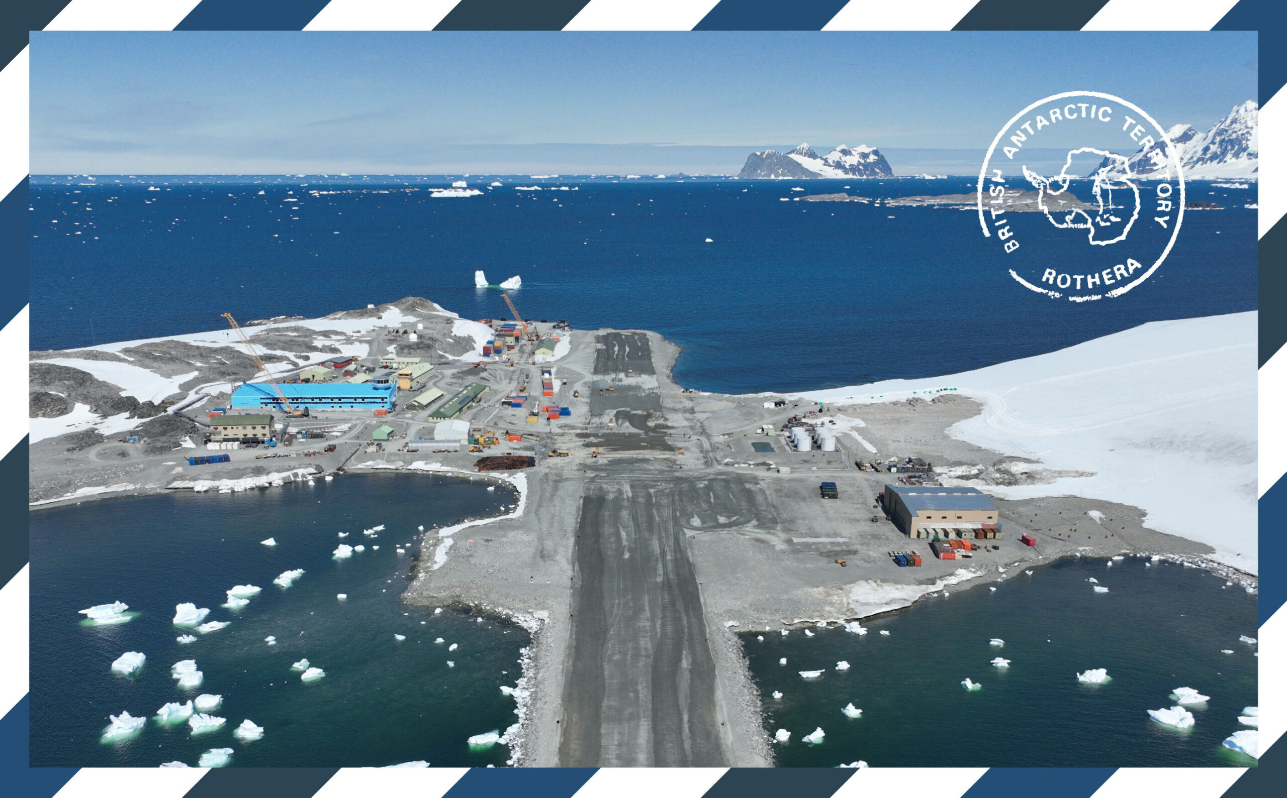 A large blue building in the background and a short runway surrounded by water and snow and a blue and white border surrounding the whole image with a franked stamp mark on the top right hand side.