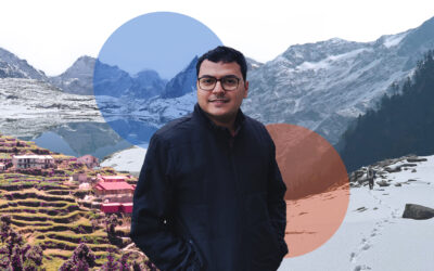 A man standing in front of a snow covered mountain