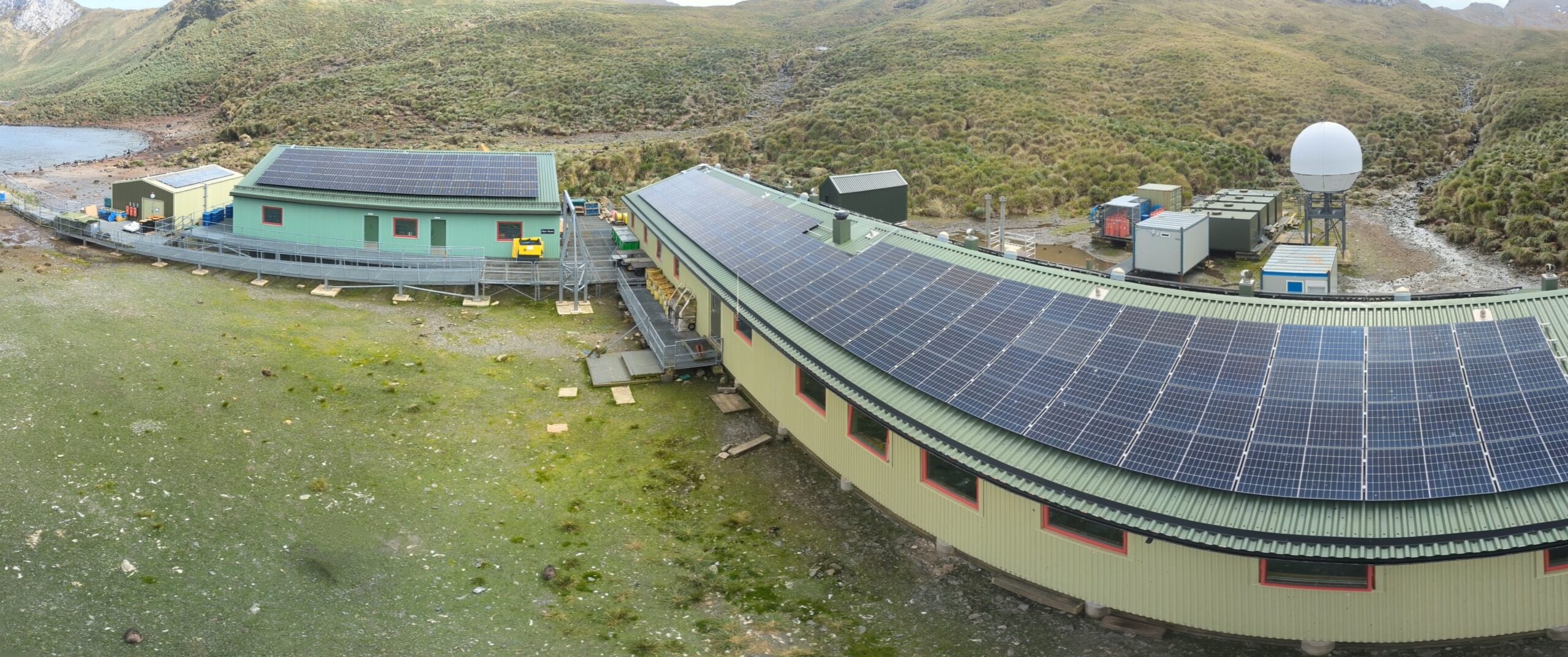 A building roof with solar panels on top.